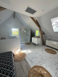 a attic room with a bed and a shower at Maison Au coeur d'Amboise in Amboise