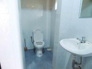 a bathroom with a toilet and a sink at Mutanda Eco Community Center in Kisoro