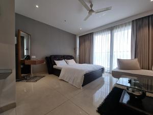 a bedroom with a bed and a desk and a window at Luxury Studios Key 1 in Gurgaon +26 photos