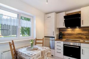 a kitchen with a table with a vase on it at Ferienwohnung Rothmund in Überlingen