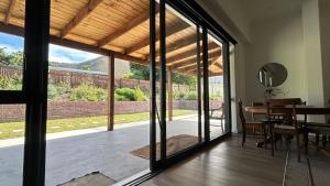 a dining room with sliding glass doors to a patio at Kiepersol in Gansbaai