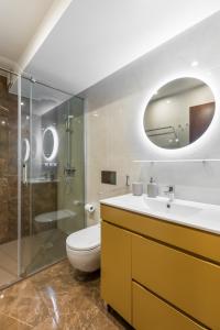 a bathroom with a toilet and a sink and a shower at Viravento - Guesthouse & Creative Space in Espinho