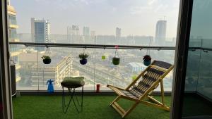 a balcony with a chair and a view of a city at Luxury Studios Key 1 in Gurgaon