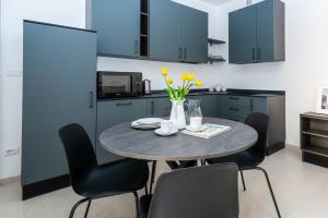 a kitchen with a table and chairs with yellow flowers at La Antica Cernobbio in Cernobbio