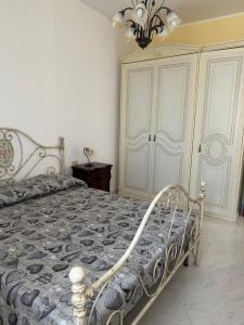 a bedroom with a bed and a chandelier at Frichi house in Lampedusa