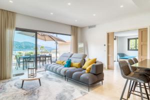 a living room with a couch and a table at Akwabay - Les Villas du Cap in Le Lavandou
