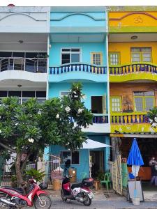 a colorful building with scooters parked in front of it at Darin's Place in Prachuap Khiri Khan