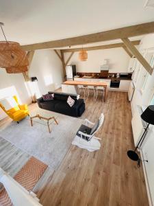 a living room with a couch and a table at Jacqueline in Étretat