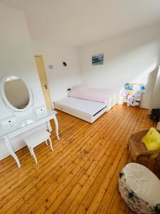 a bedroom with a bed and a dressing table and a mirror at Jacqueline in Étretat