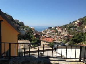 a view of a city with the ocean in the background at Estate Riomaggiore in Riomaggiore