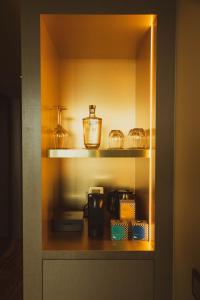 a cupboard with a shelf with various items in it at Vila Foz Hotel & SPA - member of Design Hotels in Porto