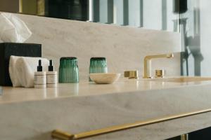 a counter top with a sink and a bowl at Vila Foz Hotel & SPA - member of Design Hotels in Porto