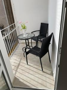 un patio con 2 sillas y una mesa en el balcón en Luxury apartmán v centru Ostravy en Moravská Ostrava