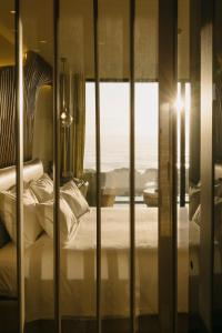 a bedroom with a bed and a window with a view at Vila Foz Hotel & SPA - member of Design Hotels in Porto