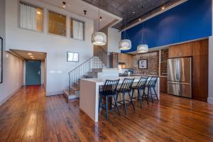 an open kitchen and dining room with a bar with stools at Nashville Riverfront Lofts in Nashville