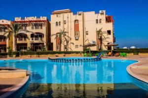 a large swimming pool in front of some buildings at Lasriena Ras Sedr-Family Only in Ras Sedr