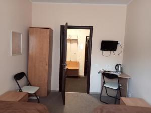 a room with a door and a room with a table and chairs at Hostel Iskra in Lviv