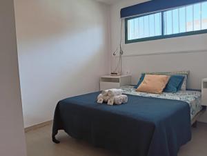 a bedroom with a bed with two stuffed animals on it at FUERTE CAMPILLOS in Costa de Antigua