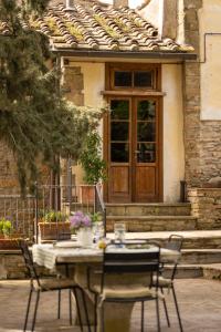 a table and chairs in front of a building at Villa Medici Donnini in Arezzo