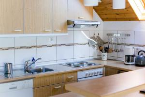 a kitchen with a sink and a stove at Haus Christof 