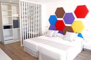 a bedroom with a bed with a colorful headboard at Alexandre Troya in Playa de las Americas +65 photos