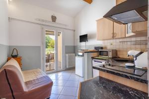 a kitchen with a sink and a stove at Gite 5 entre 2 et 4 personne in Reynès +14 photos