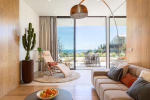 a living room with a couch and a table with a bowl of fruit at Leiro Residences in Fuengirola
