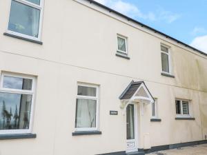 a white house with windows and a roof at Seaview in Coverack