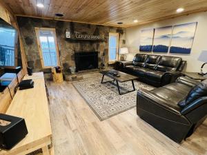 a living room with a leather couch and a fireplace at Dolly's Lodge # 3 condo in Sevierville