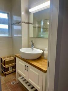 a bathroom with a white sink and a mirror at Bat Yam Garden in Bat Yam