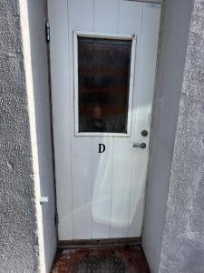 a white door with the letter d on it at Central 1BR Apartment in Narvik