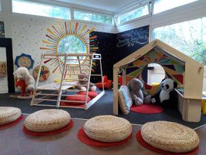a room with stuffed animals and a play room with a bed at Domaine Long Pre in Stavelot