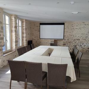 a conference room with a large white table and chairs at Hotel Restaurant Lesage in Sarzeau