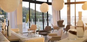 
a living room filled with chairs and tables at Hotel Kompas in Dubrovnik

