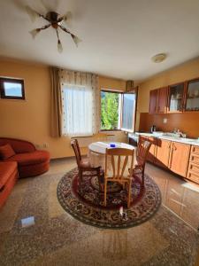 a kitchen and living room with a table and chairs at РЕЛАКС - апартамент 1 in Chepelare