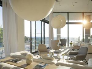 a living room with white furniture and large windows at Hotel Kompas in Dubrovnik