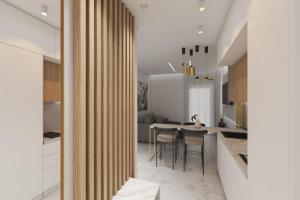 a kitchen and dining room with a table and chairs at Bellevue Luxury Apartment in Paralia Dionysiou