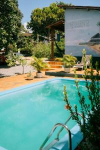 a large blue swimming pool in front of a building at Nirvana Pipa in Pipa