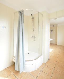 a shower with a shower curtain in a bathroom at Twój Hostel Ruda Śląska in Ruda Śląska