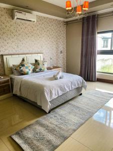 Ένα ή περισσότερα κρεβάτια σε δωμάτιο στο Riverside Boutique Mbombela +118 φωτογραφίες