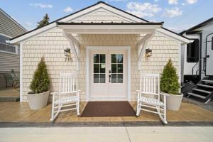 two white chairs in front of a house at Private Cottage on Annie in Coeur d'Alene