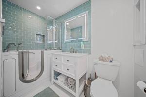 a bathroom with a toilet and a shower and a sink at Private Cottage on Annie in Coeur d'Alene +8 photos