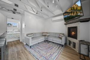 a living room with a couch and a fireplace at Private Cottage on Annie in Coeur d'Alene