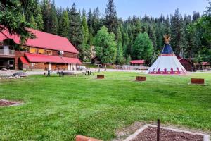 a large field with a building and a teepee at Cabin 3 at Southfork Lodge- Sleeps 2 in Lowman