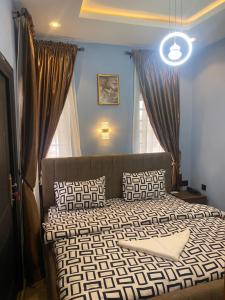 a bedroom with a bed with pillows on it at BLUE AO HOTEL AND SUITES in Lagos