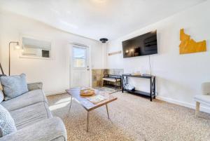 a living room with a couch and a table at CDA Loft, Minutes from Town in Coeur d'Alene