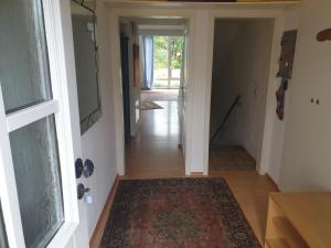 a hallway with a rug on the floor next to a door at Haus Alpenblick - b49048 in Markt Schwaben