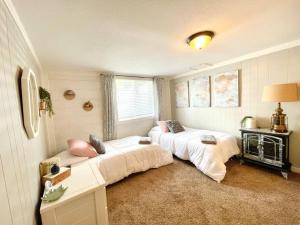 a room with two beds and a window in it at Copper Voyage, Fenced Backyard in Coeur d'Alene