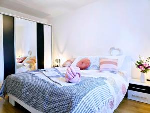 a bedroom with a bed with a pink towel on it at Ferienhaus Biograci in Široki Brijeg
