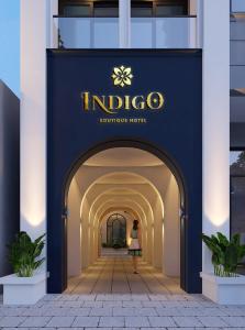 a woman walking through an archway in a building at Indigo Boutique Hotel in Cao Bằng